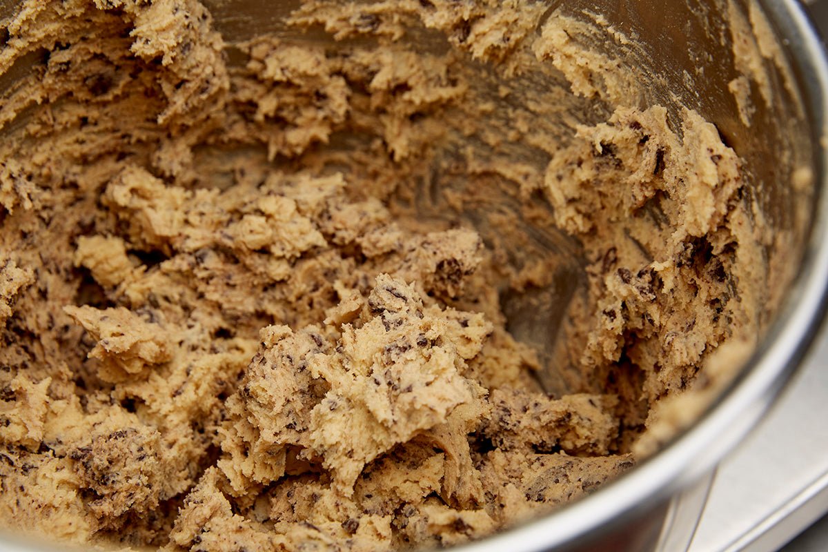 Closeup view inside a mixing bowl of a fresh batch of chocolate chip cookie dough