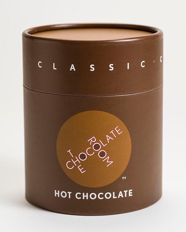 
                  
                    Classic Hot Milk Chocolate powder in a stylish branded brown container with red top
                  
                