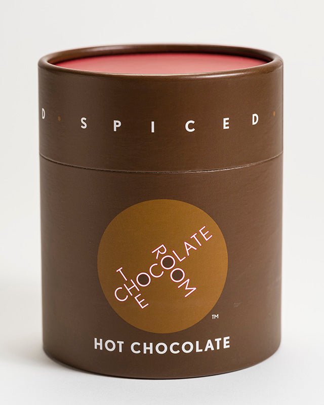 
                  
                    Spiced Hot Chocolate powder in a stylish branded brown container with red top
                  
                