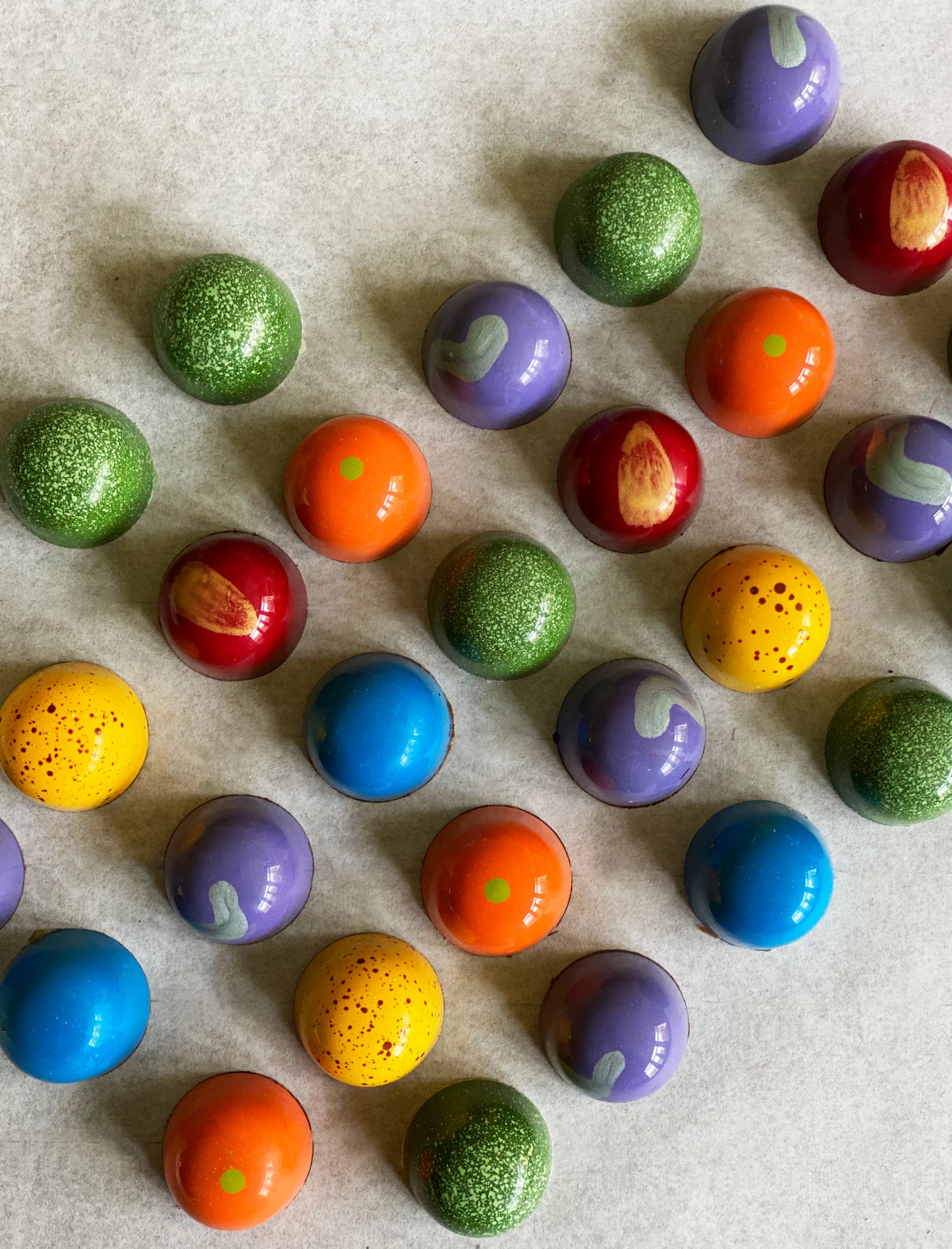 An over head shot of beautifully hand painted bonbons 