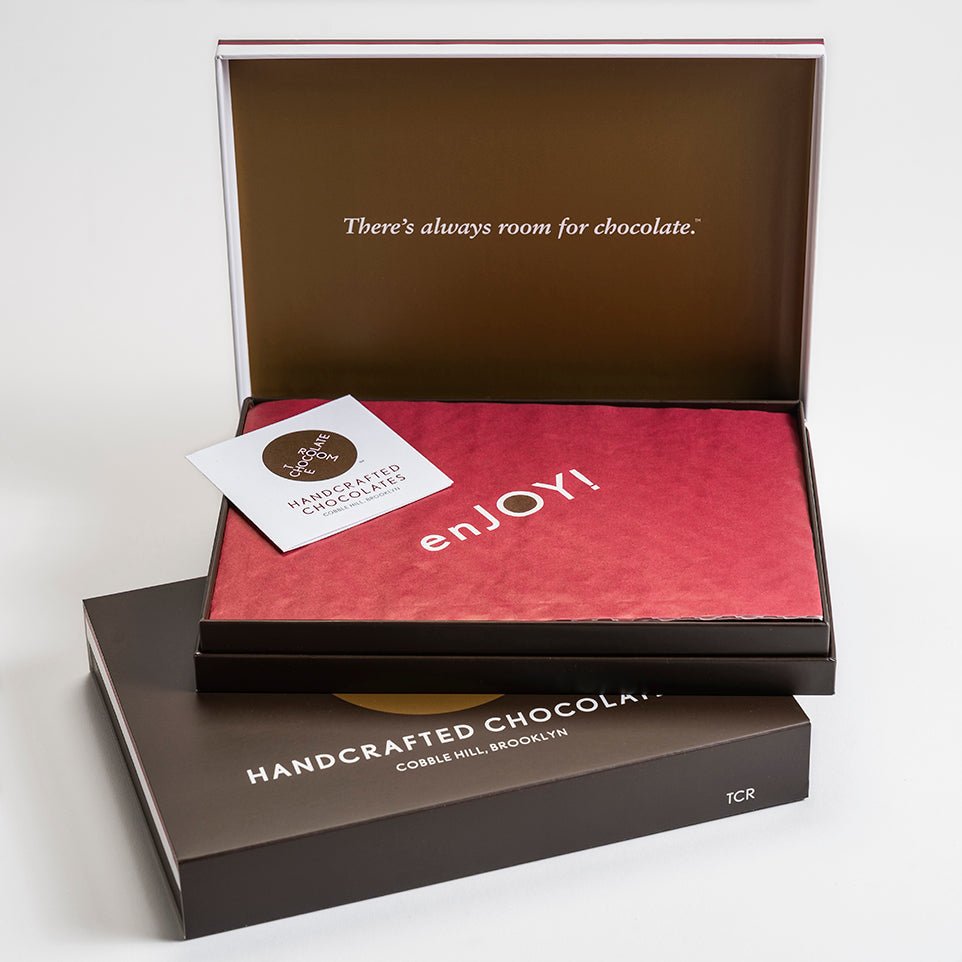 
                  
                    A stack of 2 12 piece bonbon boxes. Top on is open and say says There is always room for chocolate on the inside cover
                  
                