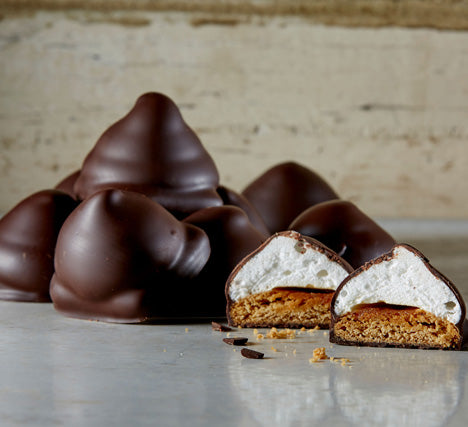 Dark Chocolate S'mores with one cut open showing a layers of graham cracker, gooey marshmallow, and rich dark chocolate