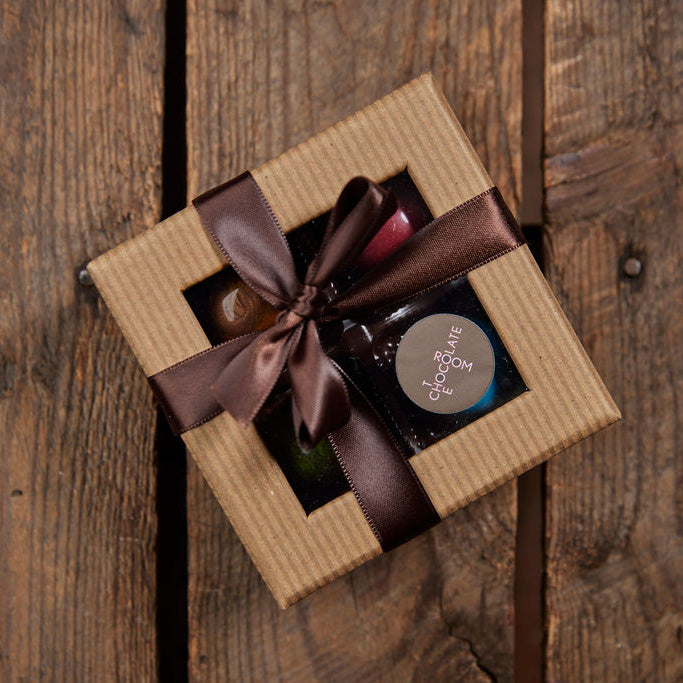 Four piece bonbon gift box with a window and a brown bow